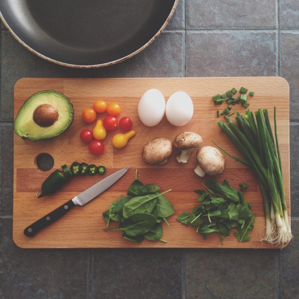 eggs, avocado and other vegetables on a chopping board, ideal food suggestions for home workout weight gain