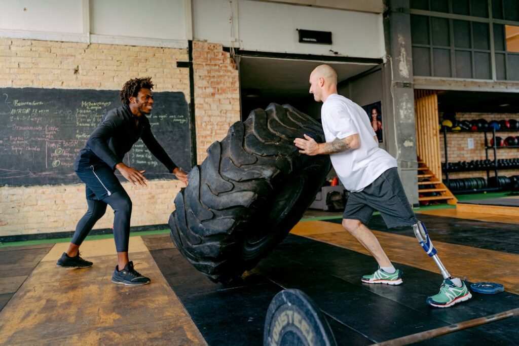 A male client with a prosthetic leg has hire a personal trainer to motivate him in his workouts